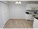 Simple dining area with laminate flooring and white kitchen cabinets at 10265 Gandy N Blvd # 705, St Petersburg, FL 33702