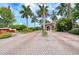 Gated entrance to Utopia Private Residences, featuring a brick road and lush landscaping at 10265 Gandy N Blvd # 705, St Petersburg, FL 33702