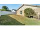 Spacious backyard with grassy area and white vinyl fence at 12006 Stone Crossing Circle, Tampa, FL 33635