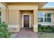 Dark brown wooden front door with a brick walkway at 12006 Stone Crossing Circle, Tampa, FL 33635