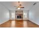 Living room featuring hardwood floors and a stone fireplace at 12006 Stone Crossing Circle, Tampa, FL 33635