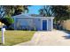 Charming single-story home featuring a blue door and a well-maintained front yard at 13625 120Th St, Largo, FL 33778