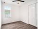 Spacious bedroom featuring wood-look floors, white walls, a large window, and closet doors at 1510 W Rambla St, Tampa, FL 33612