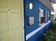 Blue house exterior with light-yellow door and wooden shutters at 1644 24Th N Ave, St Petersburg, FL 33713