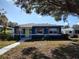 Charming blue house with a green door and landscaped yard at 1644 24Th N Ave, St Petersburg, FL 33713
