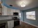 Updated kitchen with stainless steel appliances and white cabinets at 1644 24Th N Ave, St Petersburg, FL 33713