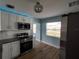 Updated kitchen with stainless steel appliances and white cabinets at 1644 24Th N Ave, St Petersburg, FL 33713
