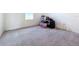 Empty bedroom with gray carpet and a window at 17209 Sabrina Cir, Port Charlotte, FL 33948