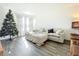 Cozy living room with a sectional sofa, decorated Christmas tree, and wood-look tile floors at 17209 Sabrina Cir, Port Charlotte, FL 33948