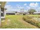 Spacious backyard with grassy area and water feature, offering a tranquil setting at 21626 Rosewood Ct, Lutz, FL 33549