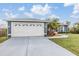 Gray house with white garage door and landscaping at 21626 Rosewood Ct, Lutz, FL 33549