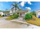 Cute 2-story house with carport, mature landscaping, and a paved driveway at 2579 Forest Run Ct, Clearwater, FL 33761