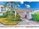 Front view of house with carport and lush landscaping at 2579 Forest Run Ct, Clearwater, FL 33761