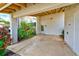 Covered patio with access to the unit and a small garden at 2579 Forest Run Ct, Clearwater, FL 33761