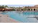 Community pool with plenty of lounge chairs and a volleyball net at 2746 Via Tivoli # 135B, Clearwater, FL 33764