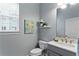 Clean bathroom with gray vanity and modern fixtures at 3192 Nautical S Pl, St Petersburg, FL 33712