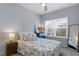 Cozy bedroom with decorative nautical bedding, side tables, and lamp at 3192 Nautical S Pl, St Petersburg, FL 33712