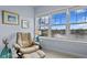 Calm bedroom with comfortable chair, ottoman and bright window with a scenic view at 3192 Nautical S Pl, St Petersburg, FL 33712
