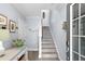 Inviting foyer with gray wood-look floors, staircase and entry door at 3192 Nautical S Pl, St Petersburg, FL 33712