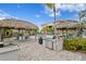 Outdoor grilling area featuring stainless steel grills, seating, and tropical landscaping at 3192 Nautical S Pl, St Petersburg, FL 33712