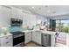 Modern kitchen with stainless steel appliances and white cabinets at 3192 Nautical S Pl, St Petersburg, FL 33712
