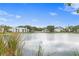 Community lakefront view with lush landscaping and residential buildings at 3192 Nautical S Pl, St Petersburg, FL 33712