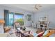 Bright living room area featuring dining table, water views, and sliding glass doors to the lanai at 3192 Nautical S Pl, St Petersburg, FL 33712