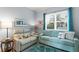 Comfortable living room with neutral decor, window with blinds and blue rug at 3192 Nautical S Pl, St Petersburg, FL 33712