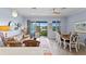 Open living and dining area with access to balcony featuring water views at 3192 Nautical S Pl, St Petersburg, FL 33712