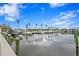 Scenic marina view with several boats docked at piers, palm trees and blue skies at 3192 Nautical S Pl, St Petersburg, FL 33712