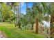 Landscaped waterfront path with palm trees and tranquil lake view at 3192 Nautical S Pl, St Petersburg, FL 33712