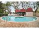 Inviting kidney-shaped pool with a covered patio area at 3211 W Swann Ave # 701, Tampa, FL 33609