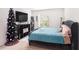 Spacious bedroom with large bed, TV, and Christmas tree at 3345 Pleasant Willow Ct, Brandon, FL 33511
