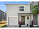 Two-story house with a gray exterior, white garage, and black front door at 3345 Pleasant Willow Ct, Brandon, FL 33511