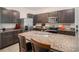 Kitchen with dark cabinets, granite countertops and stainless steel appliances at 3345 Pleasant Willow Ct, Brandon, FL 33511