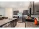 Modern kitchen with dark cabinets and granite countertops at 3345 Pleasant Willow Ct, Brandon, FL 33511