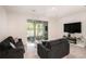 Living room with gray sectional, fireplace and sliding glass doors at 3345 Pleasant Willow Ct, Brandon, FL 33511