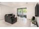 Living room with gray sectional sofa and sliding glass doors at 3345 Pleasant Willow Ct, Brandon, FL 33511