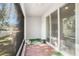 Screened patio with wood-look tile flooring, providing additional outdoor space at 3345 Pleasant Willow Ct, Brandon, FL 33511