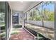 Enjoy this screened patio with wood-like tile flooring and a view of the backyard at 3345 Pleasant Willow Ct, Brandon, FL 33511