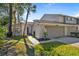 Townhome exterior showcasing a walkway and attached garage at 4234 Golf Club Ln, Tampa, FL 33618