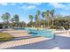 Inviting community pool with lounge chairs and palm trees at 4312 Silver Falls Dr, Land O Lakes, FL 34639