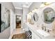 Bathroom with double vanity and a view into the bedroom at 4851 Windmill Palm Ne Ter, St Petersburg, FL 33703