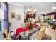 Bright dining room with glass table, chandelier, and hardwood floors at 4851 Windmill Palm Ne Ter, St Petersburg, FL 33703