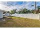 Wide shot of the spacious backyard featuring a full privacy fence and lush green grass at 500 Randolph Rd, Venice, FL 34293