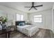 Spacious bedroom with ceiling fan, large windows, and wood-look floors at 500 Randolph Rd, Venice, FL 34293