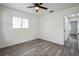Bedroom with laminate flooring, paneled walls and ceiling fan at 500 Randolph Rd, Venice, FL 34293