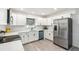 Modern kitchen with white cabinets, stainless steel appliances, and quartz countertops at 500 Randolph Rd, Venice, FL 34293