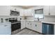 Updated kitchen featuring stainless steel appliances and white cabinetry at 500 Randolph Rd, Venice, FL 34293