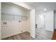 Bright laundry room with built-in shelving and vinyl flooring at 500 Randolph Rd, Venice, FL 34293